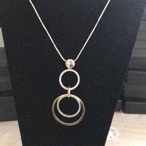 Gold tone long necklace with circle pendant
